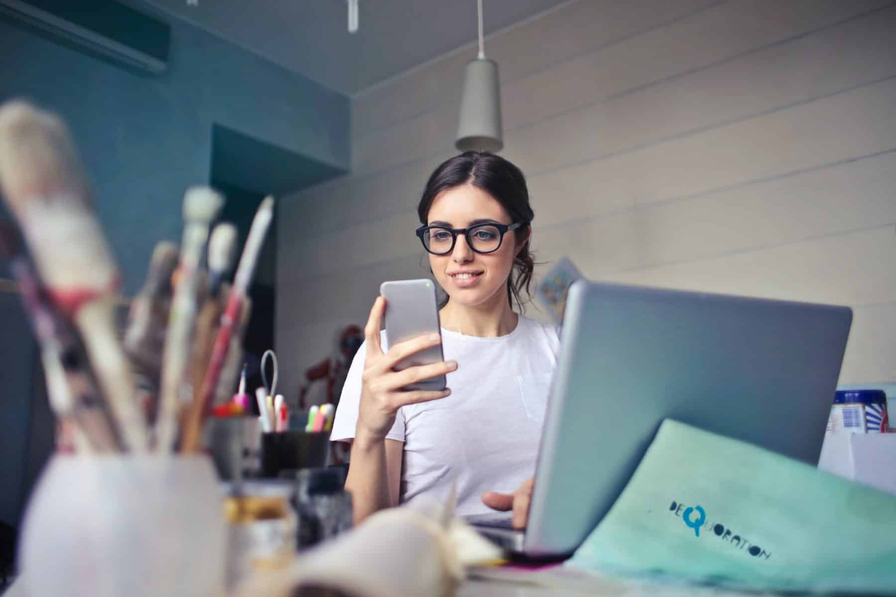 Girl with eyeglass looking at her phone