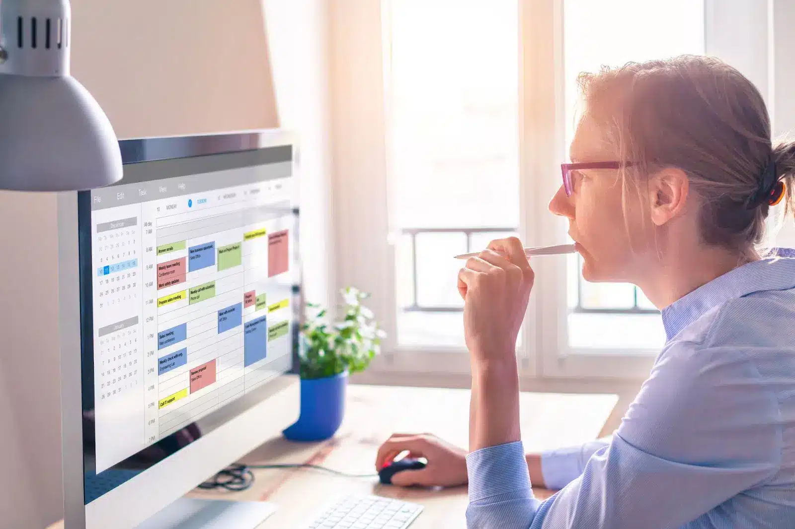 woman looking at calendar on computer