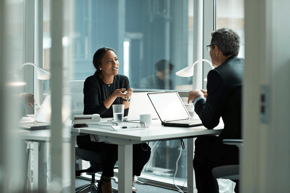 man and woman meeting with laptops