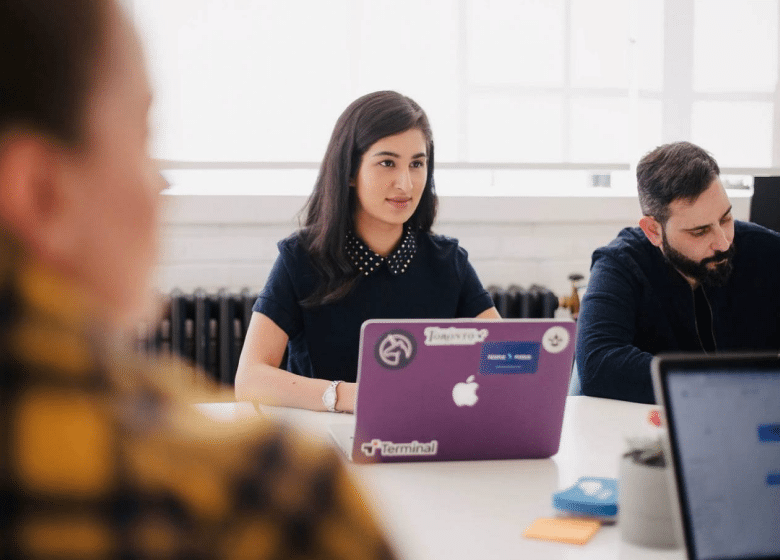 Onboarding Meeting female with computer and male writing