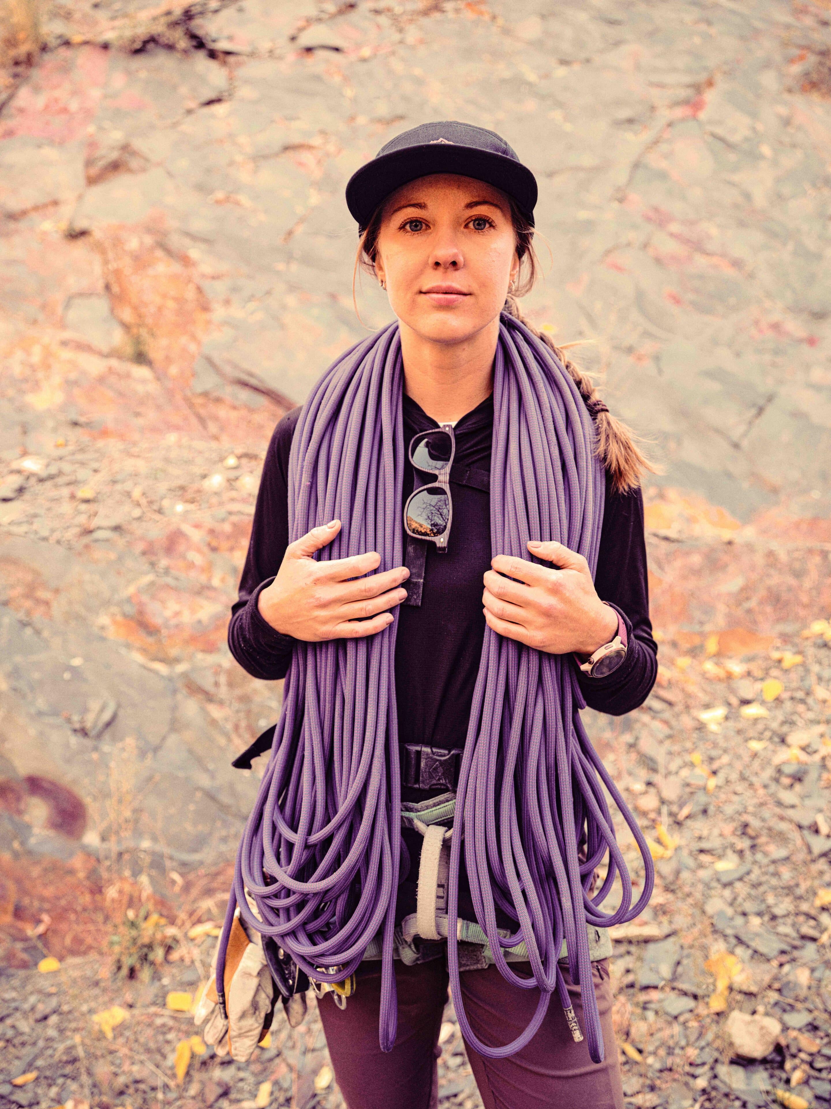 woman climbing guide with rope hanging around her neck