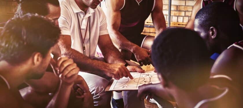 basketball coach showing a plan to players