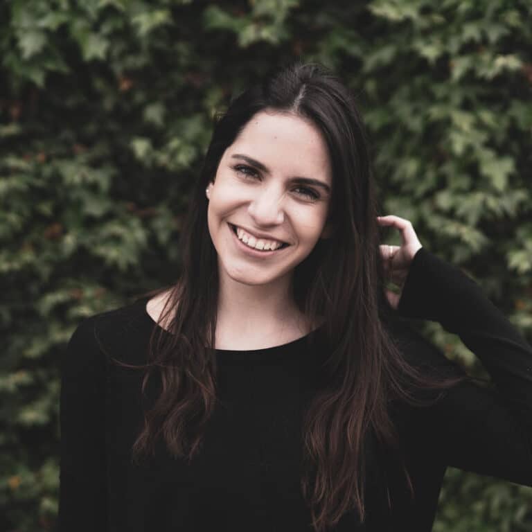 woman with trees behind her smiling