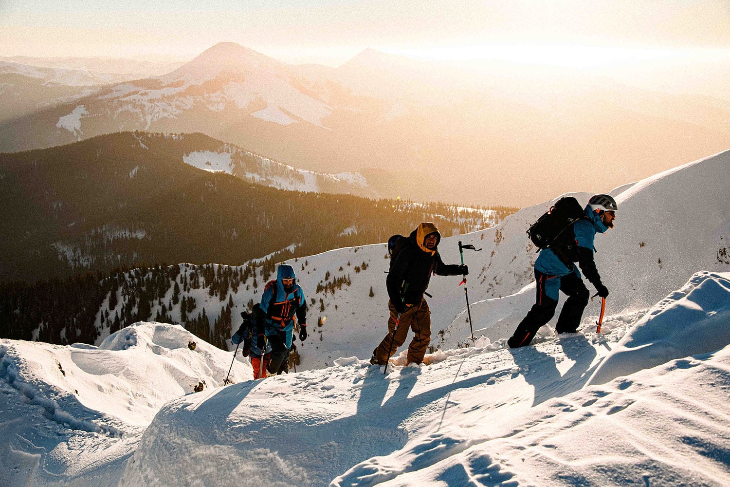 group of skiers climbing a snow-covered peak