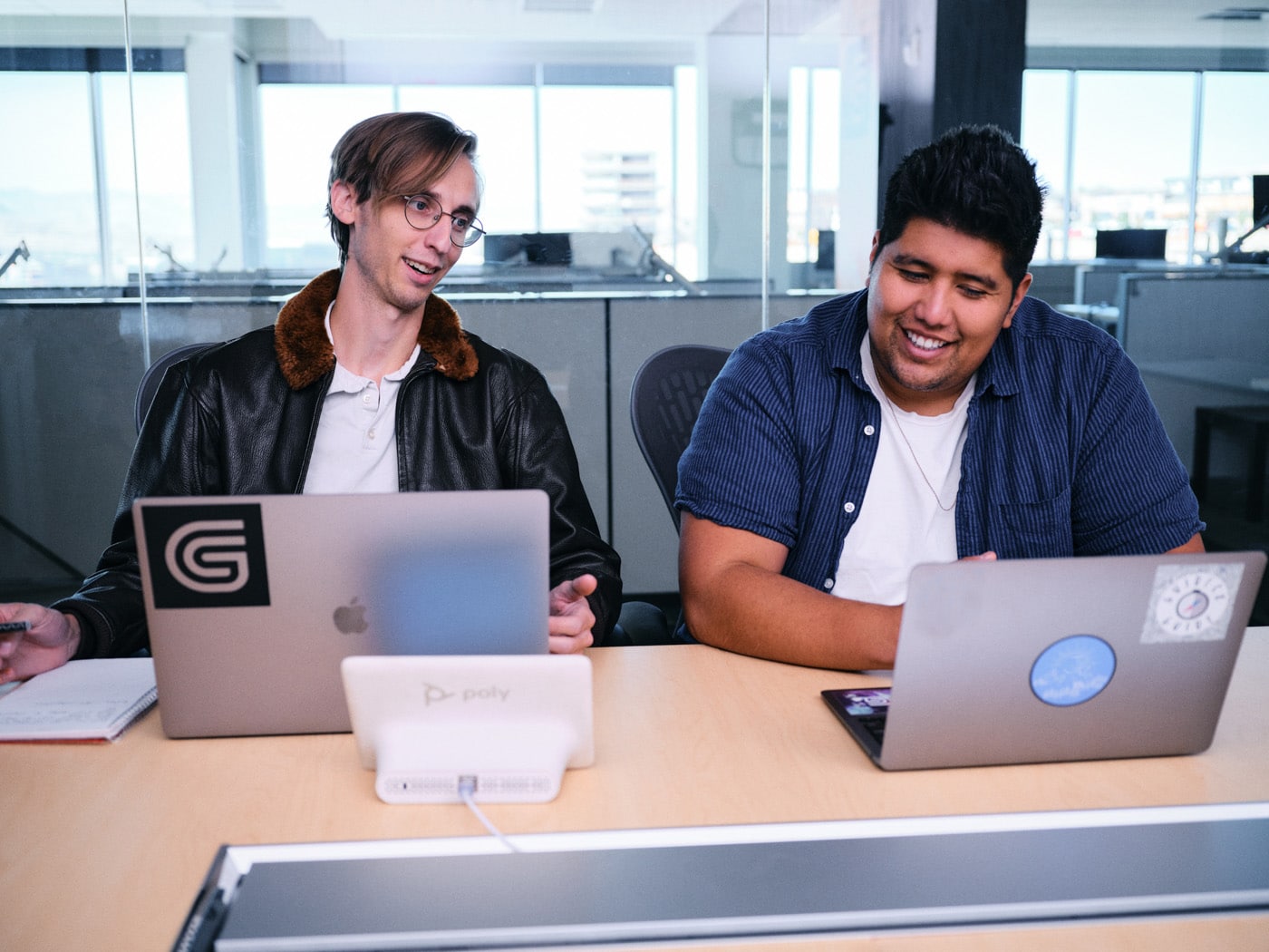 two guides smiling looking at computers