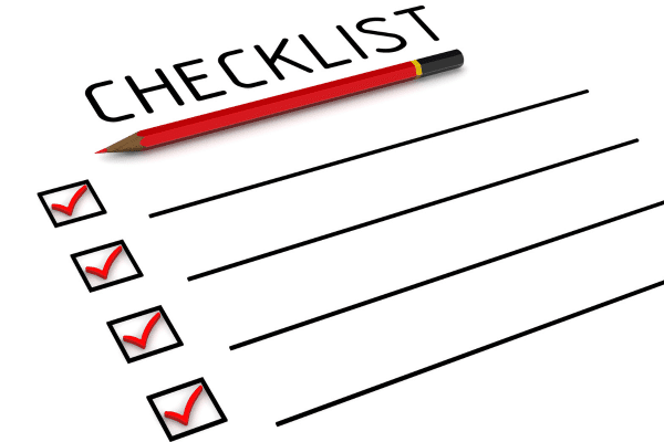 Checklist on paper with red checks in boxes.