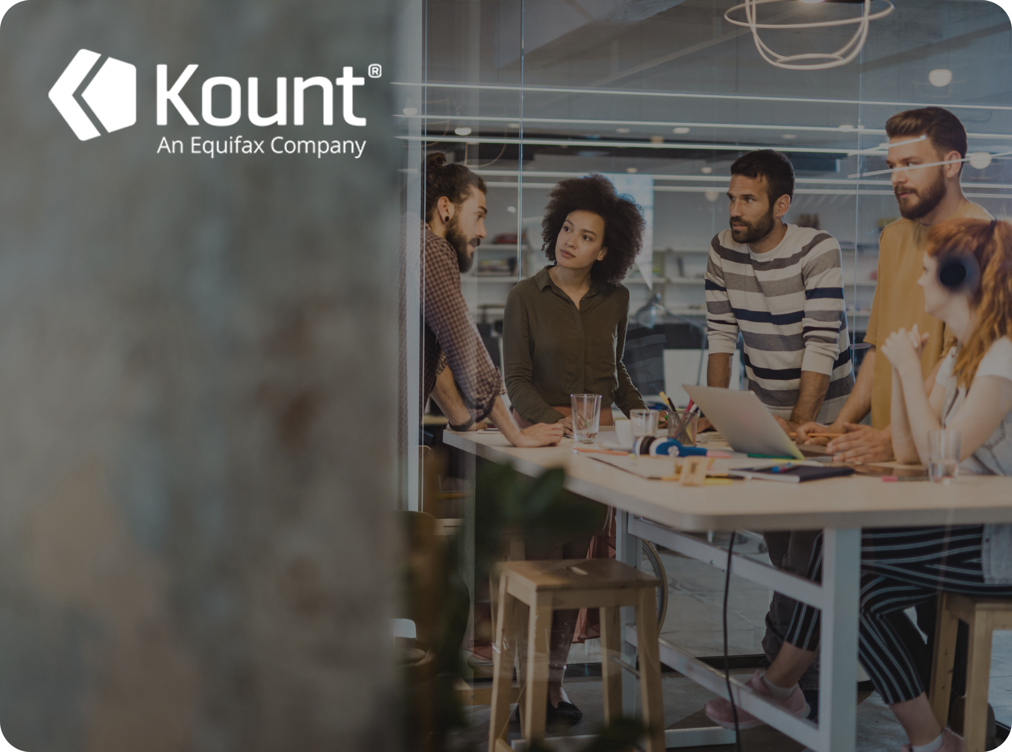 A group of people huddled around a desk.